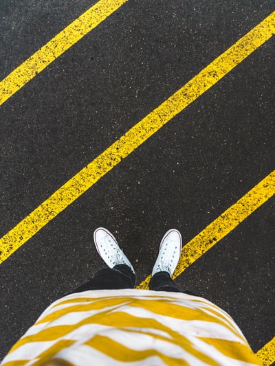 The man standing on the sidewalk
